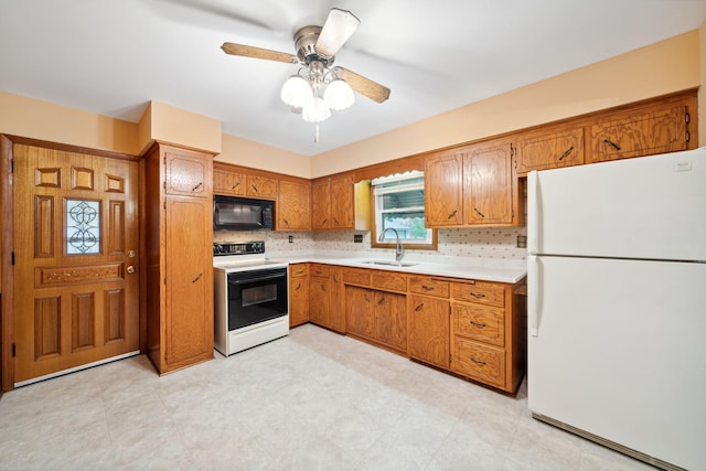 kitchen featuring tasteful backsplash, ceiling fan, sink, and white appliances