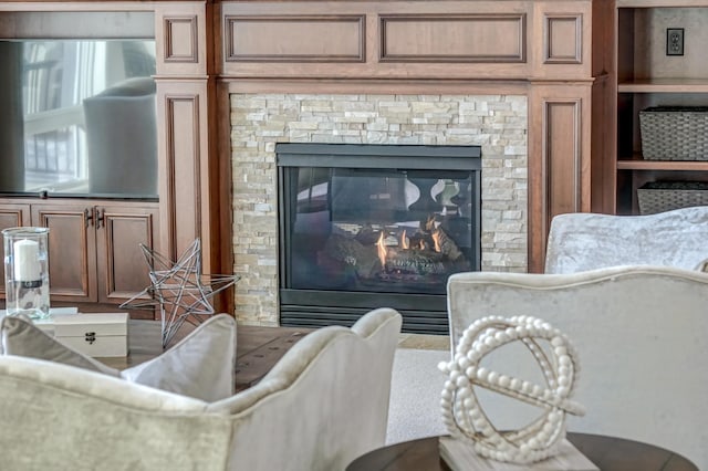 interior details featuring a stone fireplace