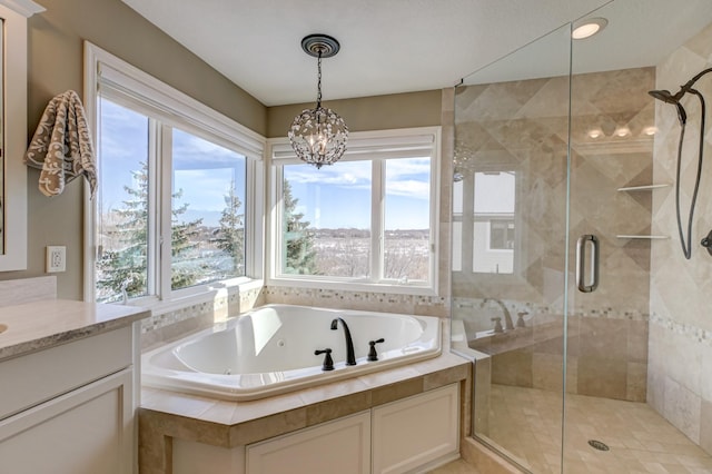 bathroom with vanity, a notable chandelier, separate shower and tub, and a wealth of natural light