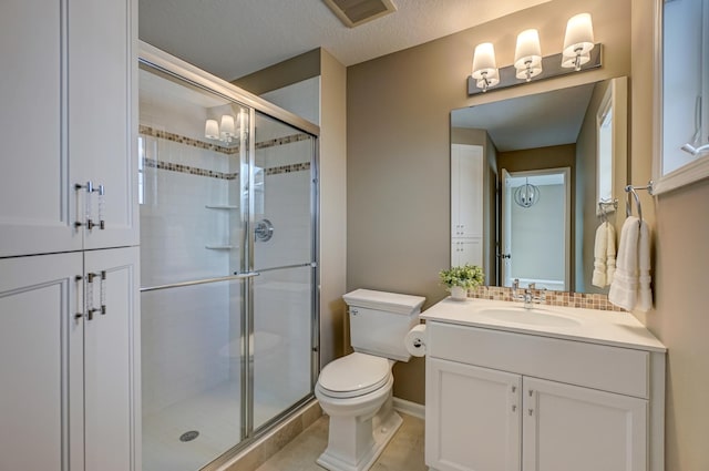 bathroom with vanity, a shower with shower door, a textured ceiling, and toilet