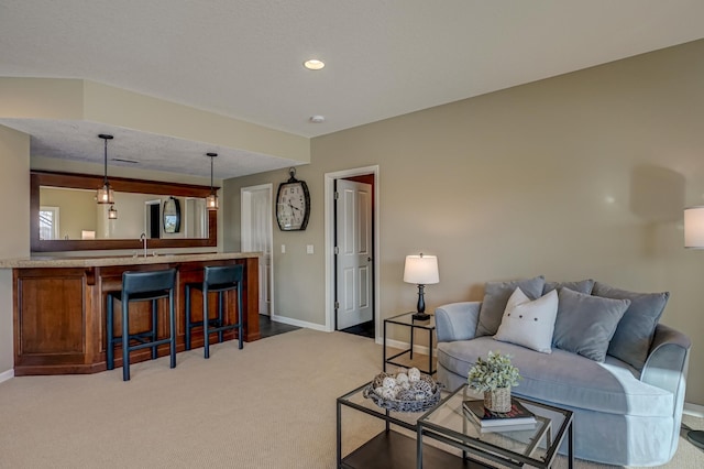 living room featuring sink and light colored carpet