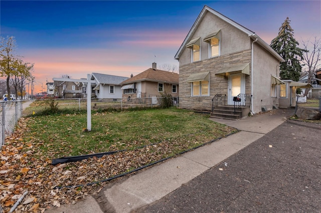 view of front of home with a yard