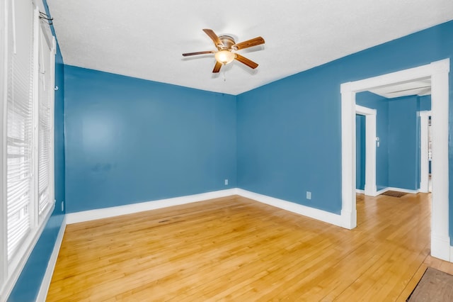 empty room featuring ceiling fan, hardwood / wood-style floors, and a textured ceiling