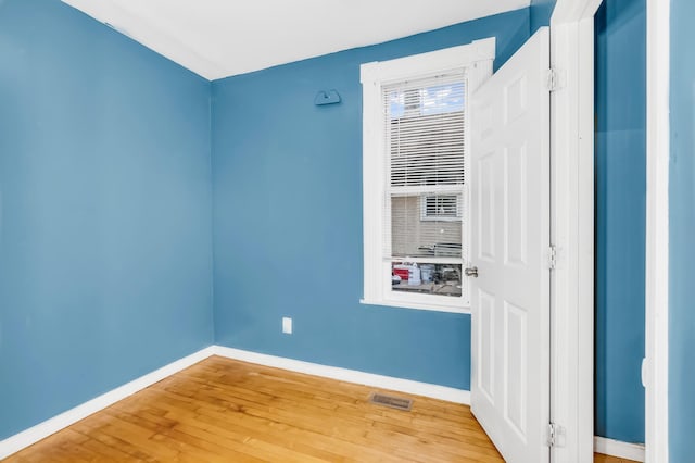 spare room featuring hardwood / wood-style floors