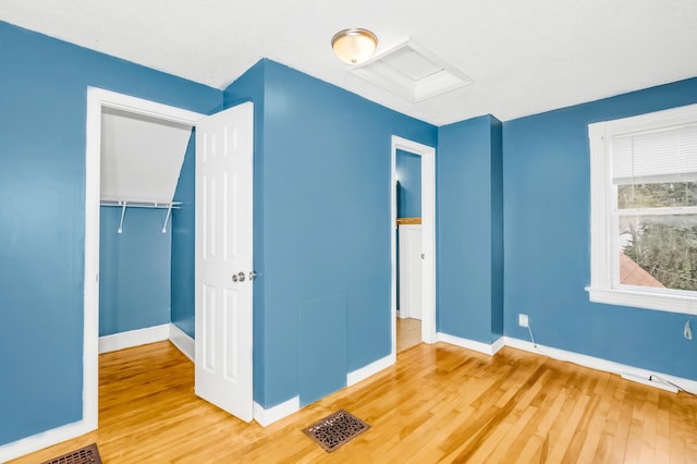 unfurnished bedroom featuring wood-type flooring and a closet