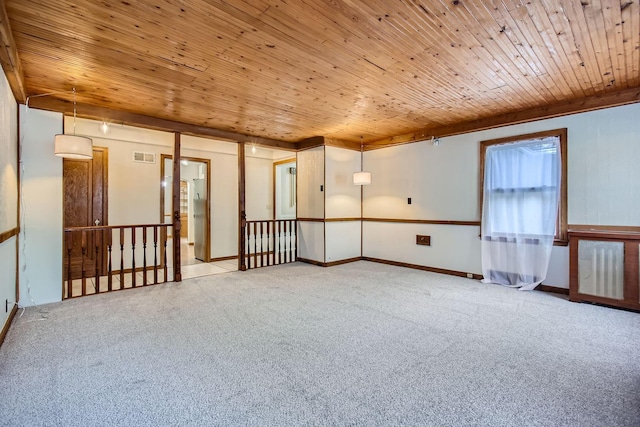 carpeted spare room with wooden ceiling