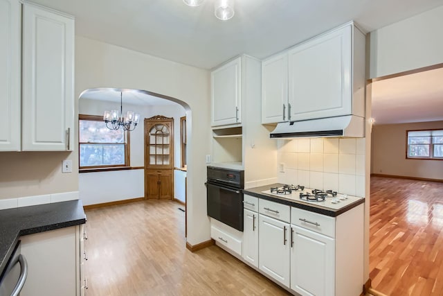 kitchen featuring oven, white gas stovetop, and white cabinets