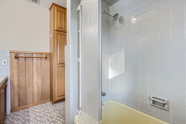 bathroom with vanity and tiled shower / bath combo