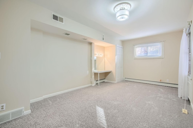 carpeted spare room with baseboard heating