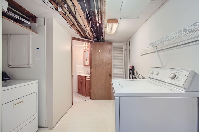 clothes washing area featuring washer and clothes dryer