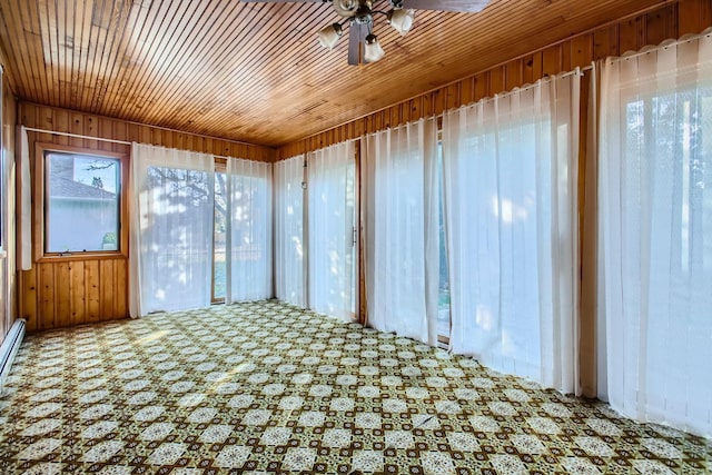 unfurnished sunroom with wood ceiling and ceiling fan