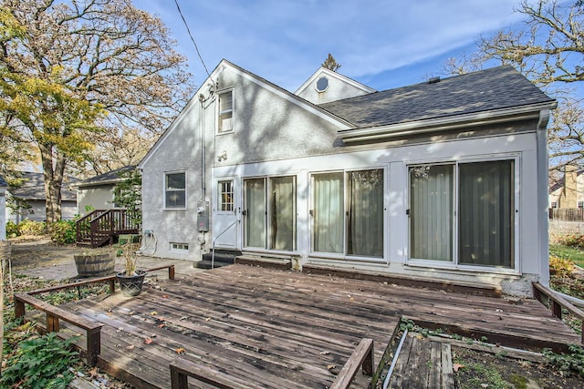 rear view of property featuring a deck