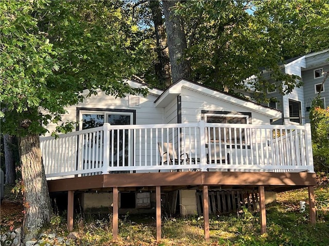 rear view of property with a wooden deck