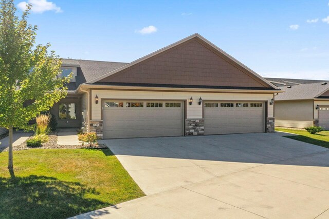 646 Shardlow Pl NE, Byron, MN 55920 - craftsman-style house featuring an attached garage, stone siding, and driveway