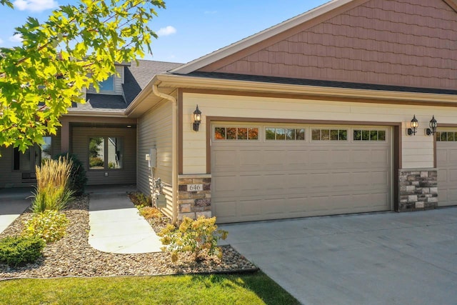 646 Shardlow Pl NE, Byron, MN 55920 - view of front of property featuring stone siding, concrete driveway, and a garage