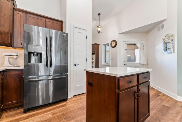 646 Shardlow Pl NE, Byron, MN 55920 - kitchen featuring light countertops, light wood-type flooring, visible vents, and stainless steel refrigerator with ice dispenser