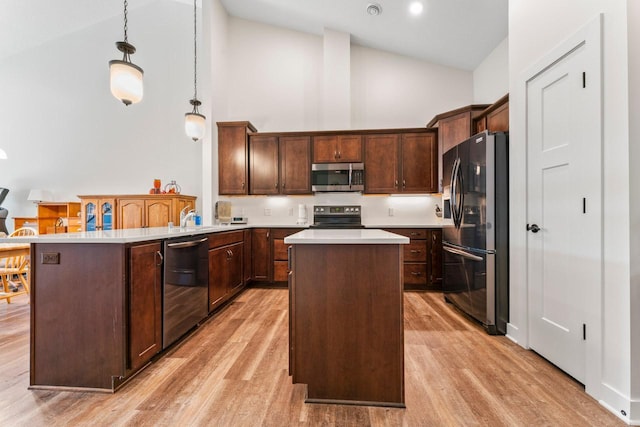 646 Shardlow Pl NE, Byron, MN 55920 - kitchen with a center island, light wood finished floors, high vaulted ceiling, light countertops, and appliances with stainless steel finishes