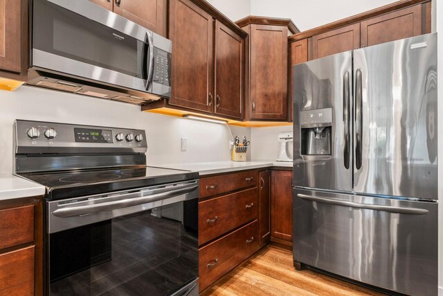 646 Shardlow Pl NE, Byron, MN 55920 - kitchen featuring light wood finished floors, stainless steel appliances, and light countertops