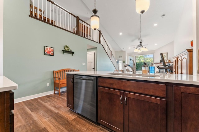 646 Shardlow Pl NE, Byron, MN 55920 - kitchen featuring stainless steel dishwasher, decorative light fixtures, dark wood finished floors, a sink, and light countertops