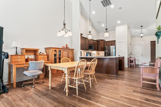 646 Shardlow Pl NE, Byron, MN 55920 - dining area featuring visible vents, wood finished floors, and high vaulted ceiling