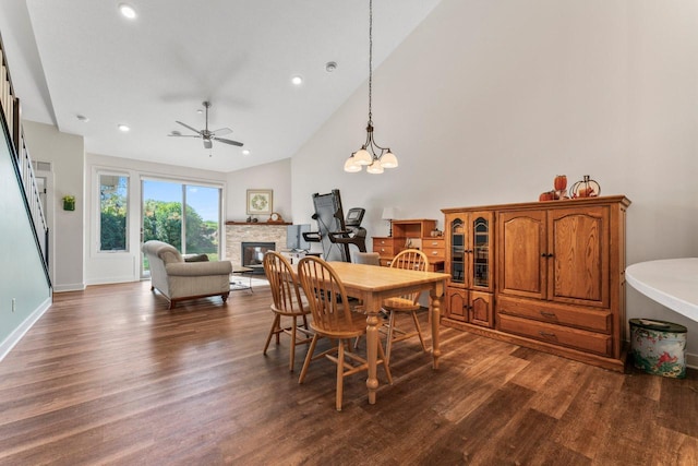 646 Shardlow Pl NE, Byron, MN 55920 - dining room with ceiling fan, dark wood-style flooring, a stone fireplace, and high vaulted ceiling