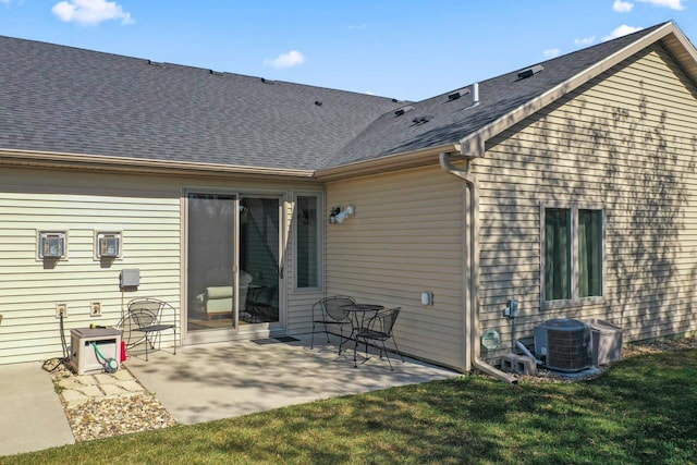646 Shardlow Pl NE, Byron, MN 55920 - back of property featuring a yard, a patio area, a shingled roof, and central AC