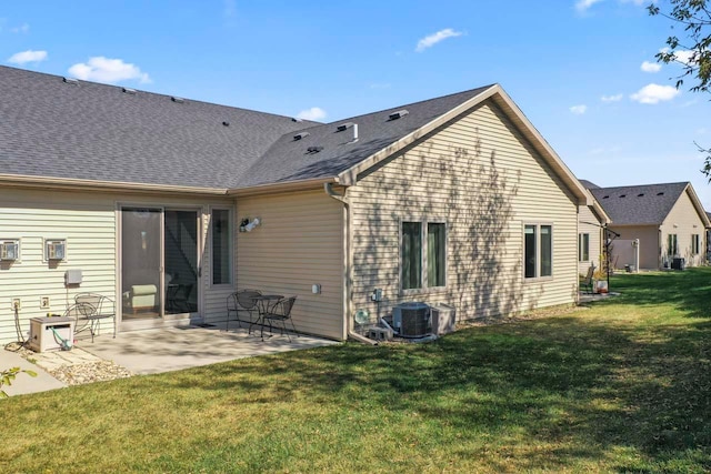 646 Shardlow Pl NE, Byron, MN 55920 - back of house featuring central air condition unit, a shingled roof, a patio, and a lawn