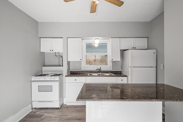 kitchen featuring white cabinetry, sink, white appliances, and light hardwood / wood-style flooring