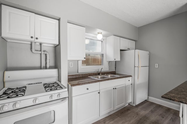 kitchen with sink, white cabinets, dark hardwood / wood-style flooring, white appliances, and a textured ceiling