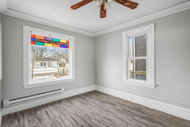 spare room featuring wood-type flooring, a baseboard radiator, ornamental molding, and a textured ceiling