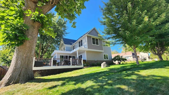 back of house featuring a deck and a yard