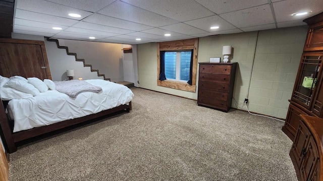 carpeted bedroom with a paneled ceiling