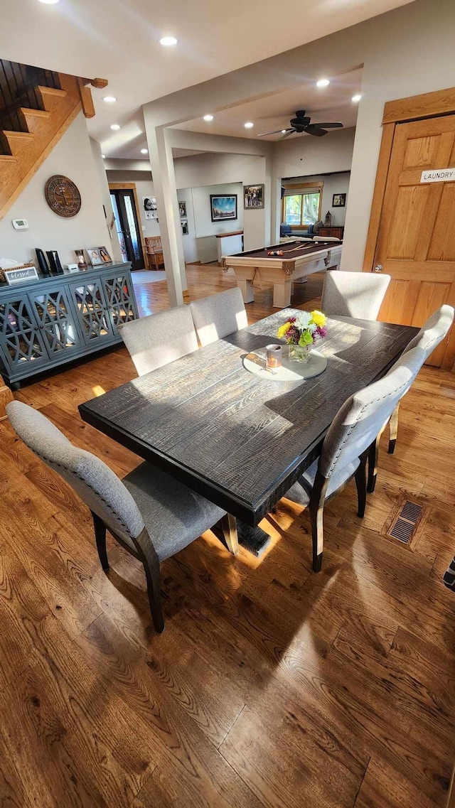 dining space with wood-type flooring and ceiling fan