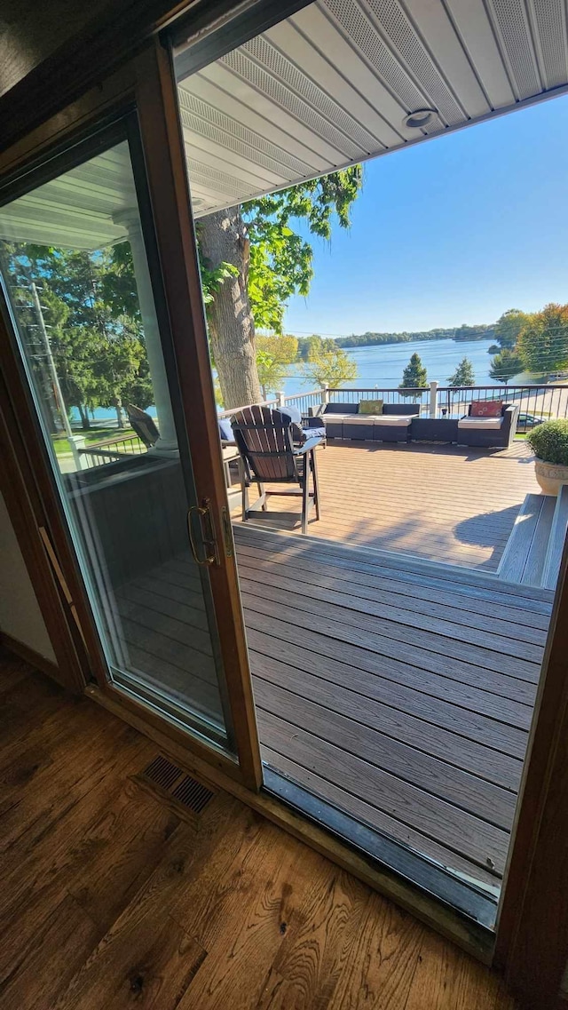 wooden terrace featuring a water view