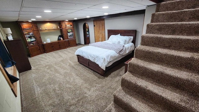 carpeted bedroom featuring a paneled ceiling