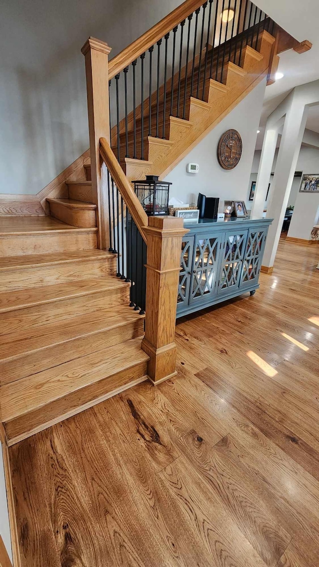 stairs with hardwood / wood-style floors