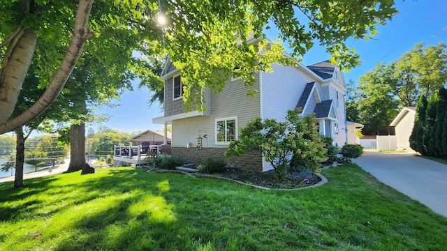 view of side of home with a lawn