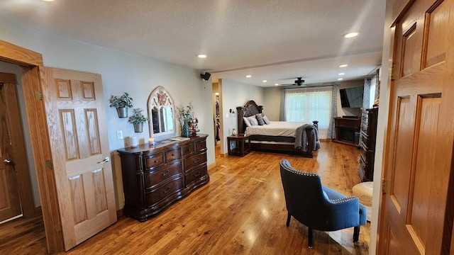 bedroom featuring light hardwood / wood-style flooring and a textured ceiling