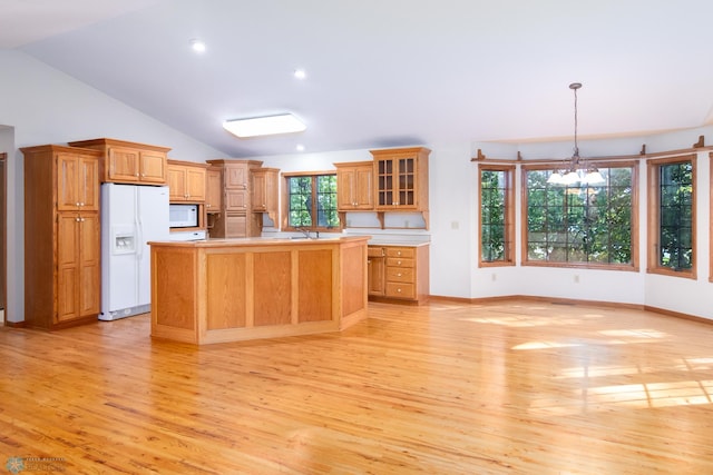 kitchen featuring a chandelier, a center island, light hardwood / wood-style flooring, white appliances, and decorative light fixtures