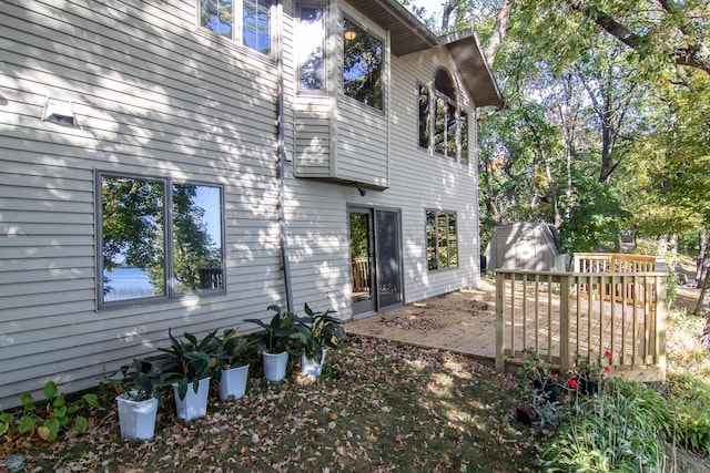 view of property exterior with a wooden deck