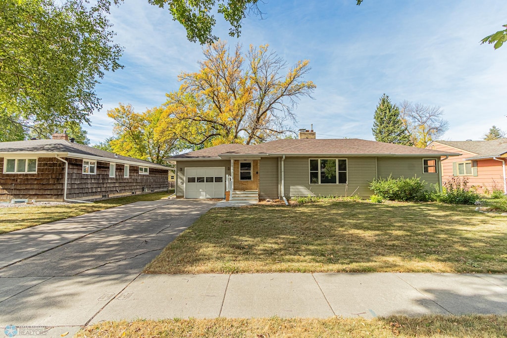 single story home featuring a front yard and a garage