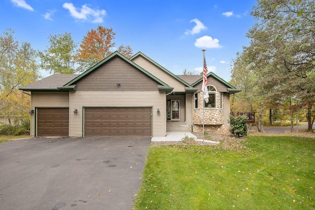 view of front of home featuring a garage and a front yard