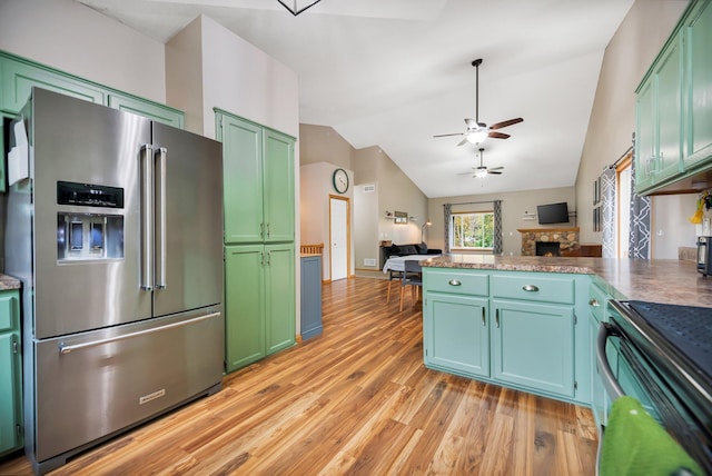 kitchen with lofted ceiling, green cabinetry, light hardwood / wood-style flooring, ceiling fan, and high end fridge