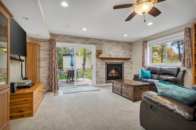 living room with light colored carpet, ceiling fan, and a healthy amount of sunlight