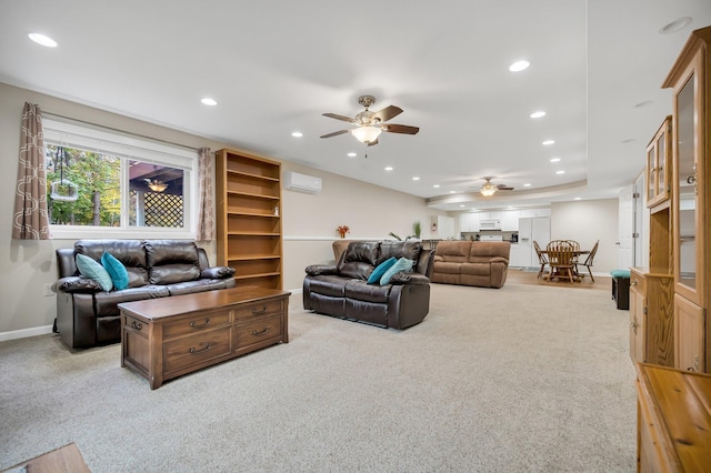 carpeted living room featuring a wall unit AC and ceiling fan