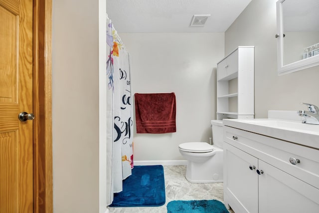 bathroom with tile patterned flooring, vanity, and toilet