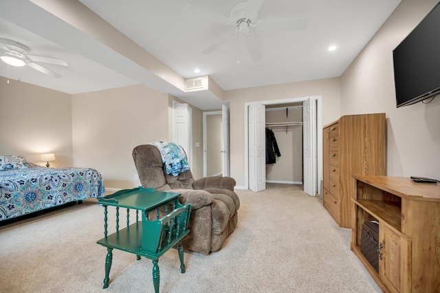 bedroom with ceiling fan, a closet, and light colored carpet