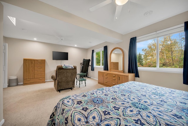 bedroom with ceiling fan and light colored carpet