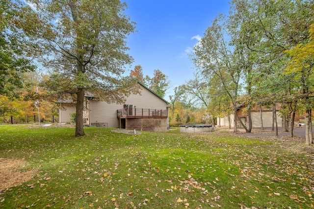 view of yard with a swimming pool side deck