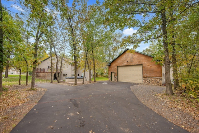 view of front facade featuring an outdoor structure and a garage